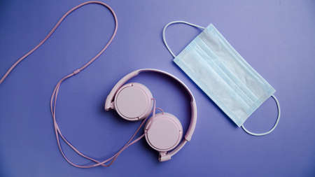 biosafety element white mask accompanied by technological objects on a unicolor background