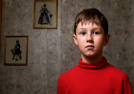 The thoughtful boy in a dark roomの写真素材