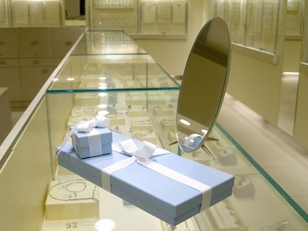 Present gift in jewerly shop. Blue boxes for jewerly near the mirrorの写真素材