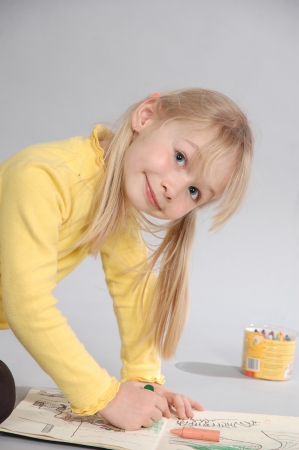 Girl blonde with blue eyes, drawing pencilsの写真素材