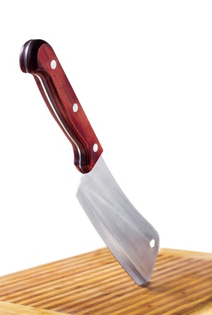 meat cleaver in cutting board isolated on whiteの写真素材