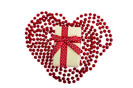 golden gift box with a red bow on white backgroundの写真素材