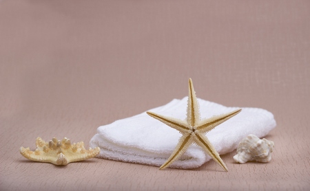 White soft towels on the biege backgroundの写真素材