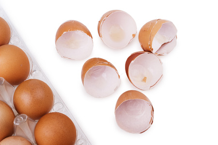 Chicken eggs and egg shell closeup isolated on white background