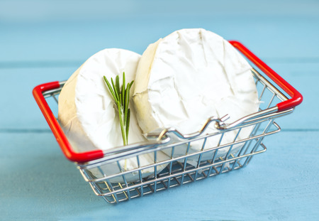 Round white cheese mold  with rosemary in the shopping cartの写真素材
