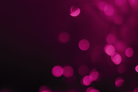 Dark red abstract christmas lights as blur backgroundの写真素材