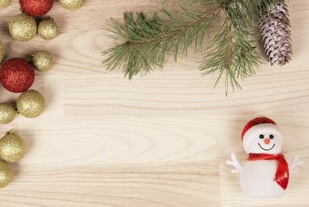 Christmas frame with a snowman: tree branches with decoration and Christmas toys  on wooden backgroundの写真素材