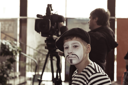 Minsk, Belarus - November 11, 2016: Sad boy actor mime in the background videographerのeditorial素材