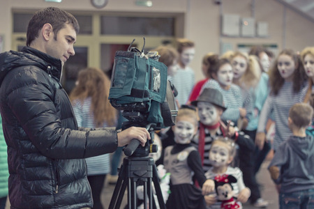 Minsk, Belarus - November 11, 2016: Video operator removes the children at the camera at a partyのeditorial素材