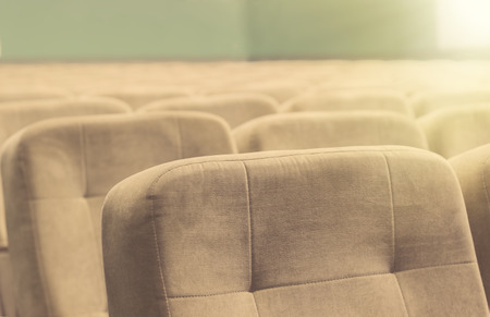 Empty auditorium with beige chairs - theatre or conference hallの写真素材