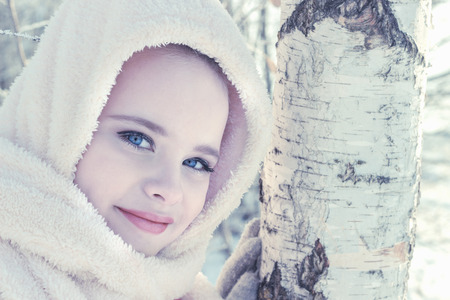 Little girl i in birch forest in winterの写真素材