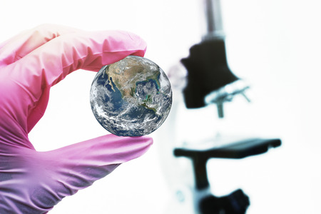 Concept study of the planet on the background of the microscope. Elements of this image furnished by...