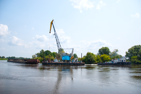 The cargo barge floats on the river.の写真素材