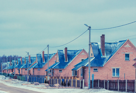 Street in the village with the same housesの写真素材