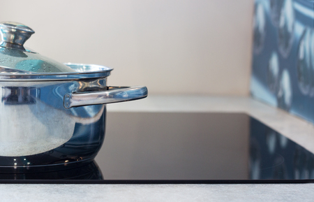 Big pot in modern kitchen with induction stove.の写真素材