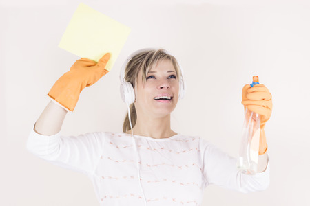 beautiful cheerful laughing woman puts the room in the headphones while listening to music.の写真素材
