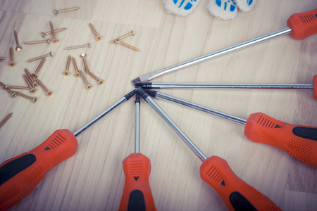 Screwdriver and set of screws on wooden background.の写真素材