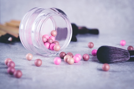 Blush in the balls and make-up brushes close-up.の写真素材