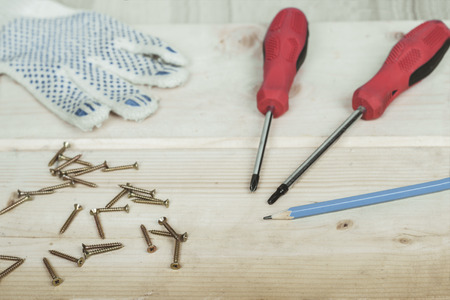 Screwdriver and set of screws on wooden background.の写真素材