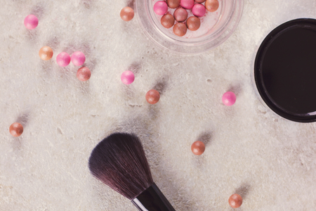 Blush in the balls and make-up brushes close-up.の写真素材
