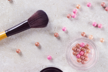 Blush in the balls and make-up brushes close-up.の写真素材