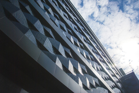 Wall of a relief building in the city against the sky