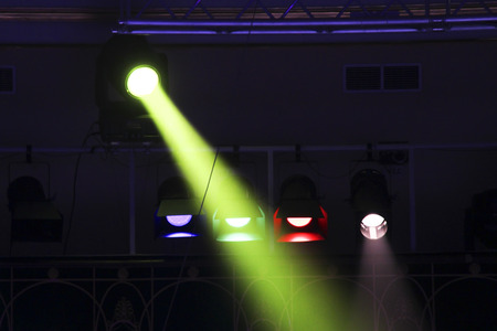 Bright floodlights attached to a steel frame. Horizontal view of multicolored floodlights attached...