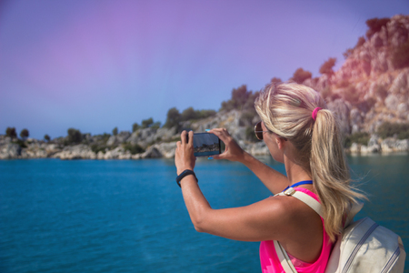 Traveling woman take a photo mountain view, travel concept.の写真素材