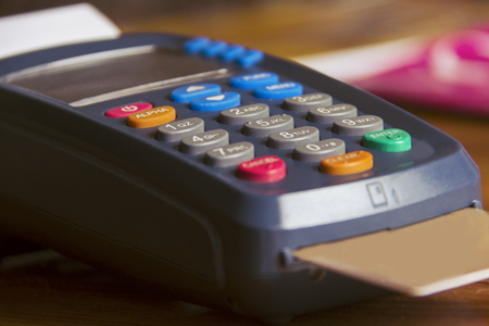 POS payment terminal on wooden background. Credit card terminal, EFTPOS terminalの写真素材