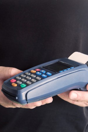 Credit card swipe through terminal for sale in store. Shopping and retail concept.の写真素材