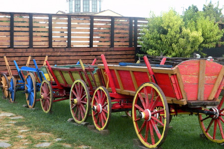 Wooden wagon stand in a row of colorful bright colors.の写真素材