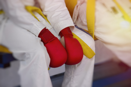 The hands of a karateka in kimono are on their knees, the concept of losing a fight in sports.の写真素材