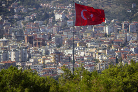 Turkish flag over the city. Alanya, Turkey. Wonderful country. At home from a height. Roofs of buildingsの写真素材