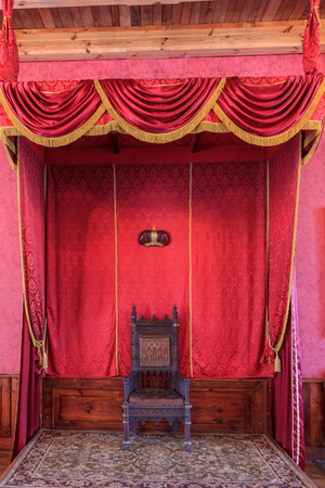 ancient throne upholstered in velvet in the interior of the palaceの写真素材