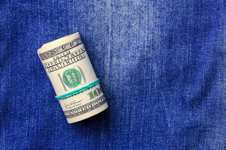 Roll of dollars on denim background, usa conceptの写真素材