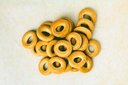 Confectionery bagels heap on cooking paper. Heap confectionery bagels on parchment paper