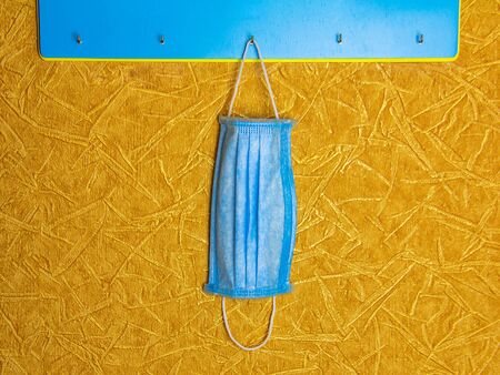 Personal protective mask. A medical mask on a hanger is used to go out during a pandemic or enter the patient s room.の写真素材