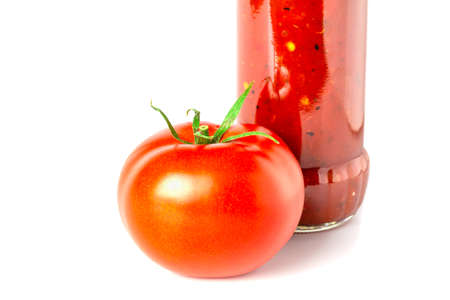 Tomato with sauce in a glass bottle close up isolated on white background.の写真素材