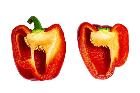 Bell pepper cut into two halves. Red pepper cut into two parts, isolate.