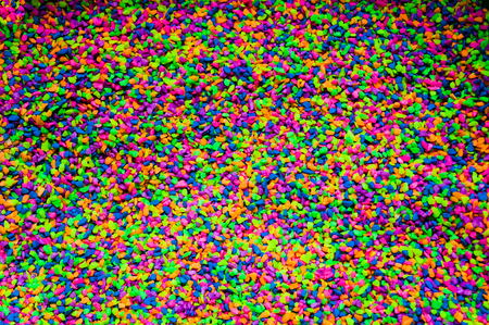 Vibrantly colorful pebbles spread is beautiful background.