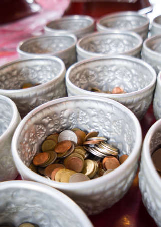 Coin in the donation bowlの写真素材