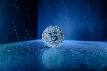 bitcoin in blue background and water droplets like rainの写真素材