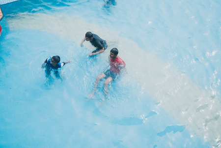 kids swimming in the swimming poolのeditorial素材