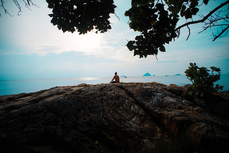 Women sit at the seaside resting and watching the seaの写真素材