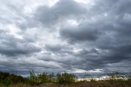 dark clouds, heavy clouds over the landscape, rainy clouds, dramatic sky sceneryの写真素材