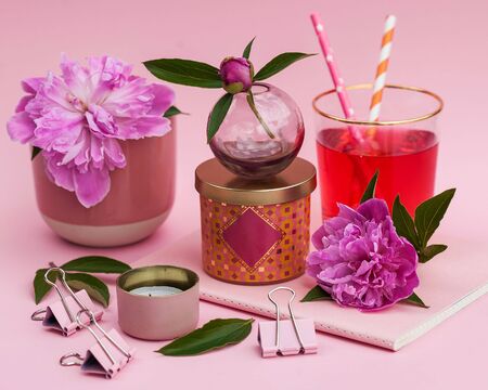 Still life of peonies, Notepad, candles on a pink background. Postcard layout for Valentine's day,...