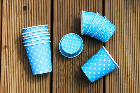 Paper cups and cookie cutters for blue cupcake with white polka dotsの写真素材