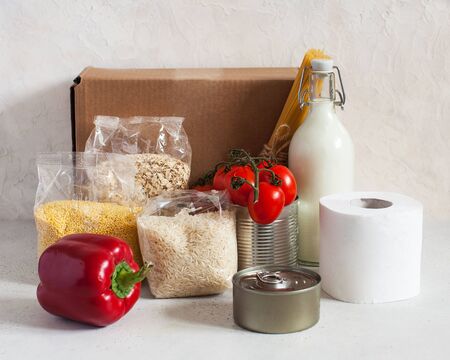 Box with food supplies crisis food supply for the period of quarantine isolation. Cereals, canned...