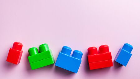  Kids flatlay. Children's block constructor on a colored background The concept of development and parenting. designer, sorter, creative. Leisure and hobbies of the child. Copy space.の写真素材