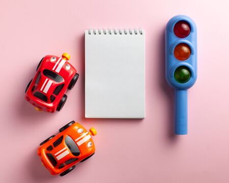 Toy traffic light close-up on a colored background. Art concept of road traffic, accidents, traffic...